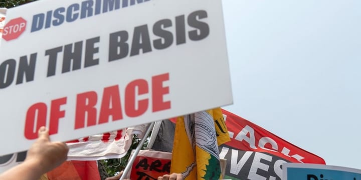 Sign reading stop discrimination on the basis of race.